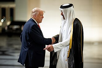 President Donald Trump is greeted by Amir of Qatar Sheikh Tamin bin Hamad Al Thani at Lusail Palace in Doha, Qatar, Wednesday, May 14, 2025, to attend an official State Dinner. (Photo by The White House - https://www.flickr.com/photos/202101414@N05/54522108163/, Public Domain, https://commons.wikimedia.org/w/index.php?curid=165337331)
