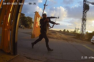 Hamas soldier storming Alumim in southern Israel during October 7 Massacre.  Photo by CCTV footage: No human authorship - https://www.i24news.tv/en/news/israel-at-war/1701089730-watch-cctv-footage-shows-gas-station-employees-hiding-from-hamas-terrorists, Public Domain, https://commons.wikimedia.org/w/index.php?curid=142152140