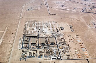 An aerial overhead view of "Ops Town" at at Al Udeid Air Base (AB), Al Rayyan Province, Qatar (QAT), taken from a US Air Force (USAF) KC-135 Stratotanker during Operation IRAQI FREEDOM..  Photo by US gov - https://research.archives.gov/id/6684299, Public Domain, https://commons.wikimedia.org/w/index.php?curid=6925360