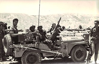 Fighters of the Shaked Patrol. Amos Yarkoni, unit commander, sits in the Jeep commander's chair, behind the machine gun. Sinai, Six-Day War, June 1967. By Rafi Rogel (??? ????), Attribution, https://commons.wikimedia.org/w/index.php?curid=12890720
