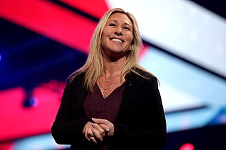 Marjorie Taylor Greene speaking with attendees at the 2021 AmericaFest in Phoenix  AZ.  Photo by Gage Skidmore from Surprise, AZ, United States of America - Marjorie Taylor Greene, CC BY-SA 2.0, https://commons.wikimedia.org/w/index.php?curid=113608769