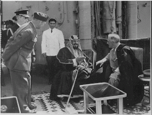 Franklin D. Roosevelt and King Ibn Saud of Saudi Arabia at Great Bitter Lake in Egypt. Photo by Roosevelt, Franklin D. (Franklin Delano), 1882-1945 - File URL Catalog record, Public Domain, https://commons.wikimedia.org/w/index.php?curid=193046606