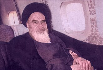 Ruhollah Khomeini in airplane. Photo by Unknown author - Imam Khomeini Website, Public Domain, https://commons.wikimedia.org/w/index.php?curid=144056366