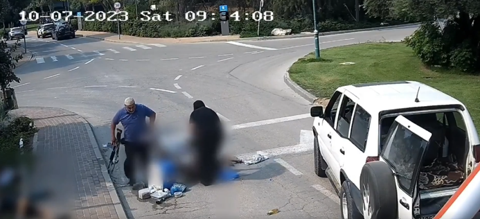 Security camera footage capturing two Hamas terrorists, who were also UNRWA employees, as they loaded the body of a murdered Israeli civilian onto a truck on October 7.  Screengrab via X