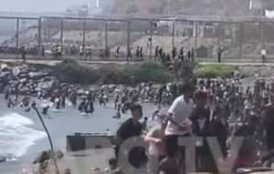 Thousands of migrants storming the Spanish coastline. Screengrab via X