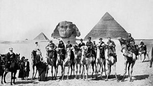  A few of the 39 participants of the en:1921 Cairo Conference, under the face of the Sphinx and from left to right : Winston Churchill, Gertrude Bell and T.E. Lawrence. By George M. Georgoulas - <a rel="nofollow" class="external free" href="https://gertrudebell.ncl.ac.uk/p/gb-pers-f-002">https://gertrudebell.ncl.ac.uk/p/gb-pers-f-002</a> (Note: original picture is owned by Newcastle University library, see <a rel="nofollow" class="external free" href="https://collectionscaptured.ncl.ac.uk/digital/collection/p21051coll46/id/0/">https://collectionscaptured.ncl.ac.uk/digital/collection/p21051coll46/id/0/</a> . Newcastle charges for scans and claims copyright but this is almost assuredly incorrect. If the author is unknown, this picture qualifies for Egypt public domain rules for anonymous works. If the author is GM Georgoulas, the picture should qualify as "non-creative" as the intent was not artistic, and qualify for PD-Egypt on those grounds.), Public Domain, <a href="https://commons.wikimedia.org/w/index.php?curid=89102795">Link</a>